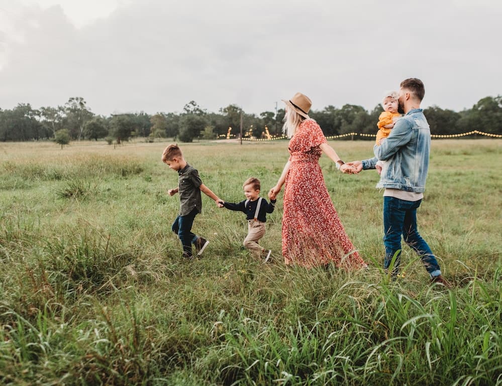 Family walking together outdoors during a portrait session